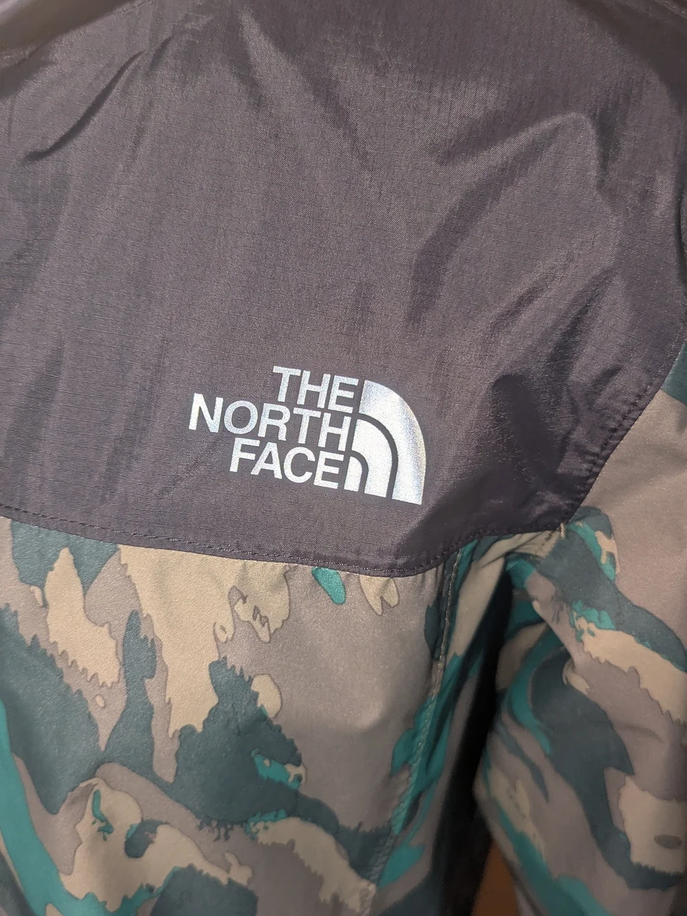 The North Face Kids Hooded Raincoat in Black and Green Camo